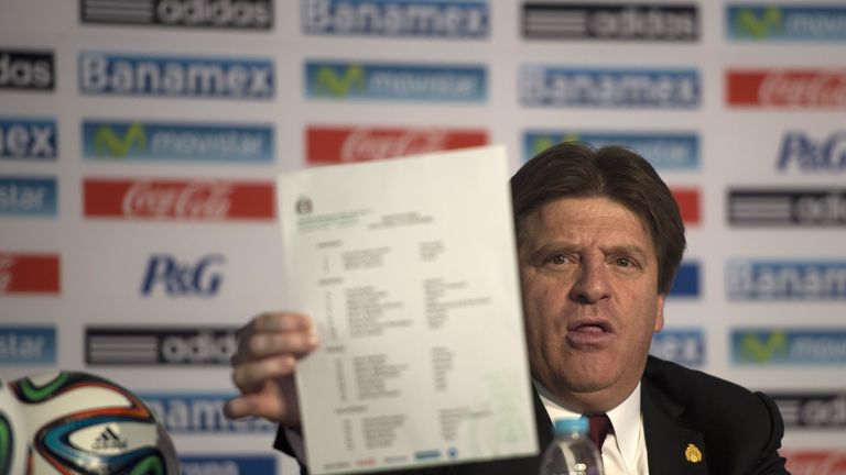 Mexico's  national football team coach Miguel Herrera shows the list of footballers who will take part in the next FIFA 2014 Brazil World Cup, during a pre