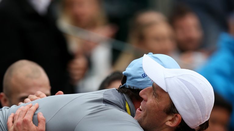 Ivo Karlovic celebrates victory with his team after his victory against Grigor Dimitrov at the French Open