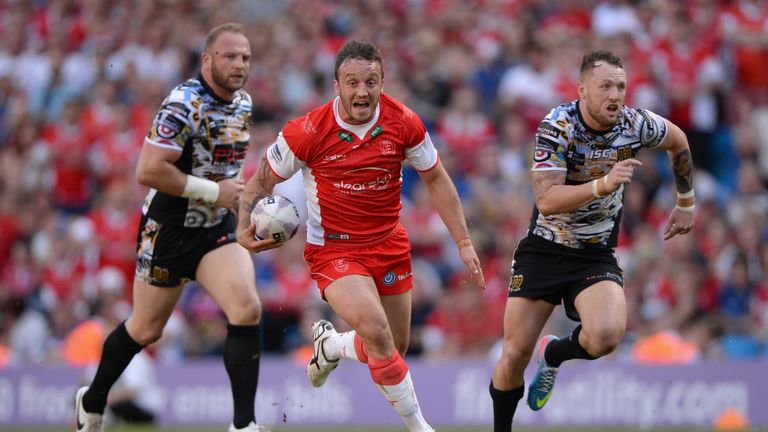 Josh Hodgson of Hull Kingston Rovers makes a break past Garreth Carvell and Jordan Rankin of Hull FC