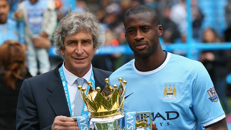 Manuel Pellegrini and Yaya Toure pose with the Premier League trophy