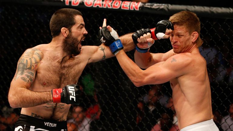 Matt Brown punches Mike Pyle in their UFC welterweight bout at TD Garden on August 17, 2013