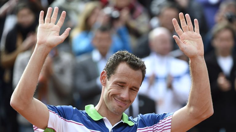 Michael Llodra acknowledges the audience during a ceremony held on the occasion of his last match at the French Open