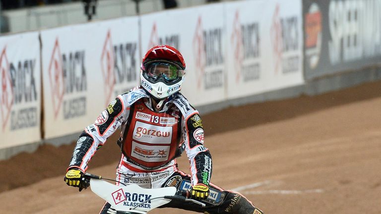Denmark's Niels-Kristian Iversen stretches out his leg after winning the final of the FIM speedway GP World Championship 2013 at Friends Arena in Stockholm