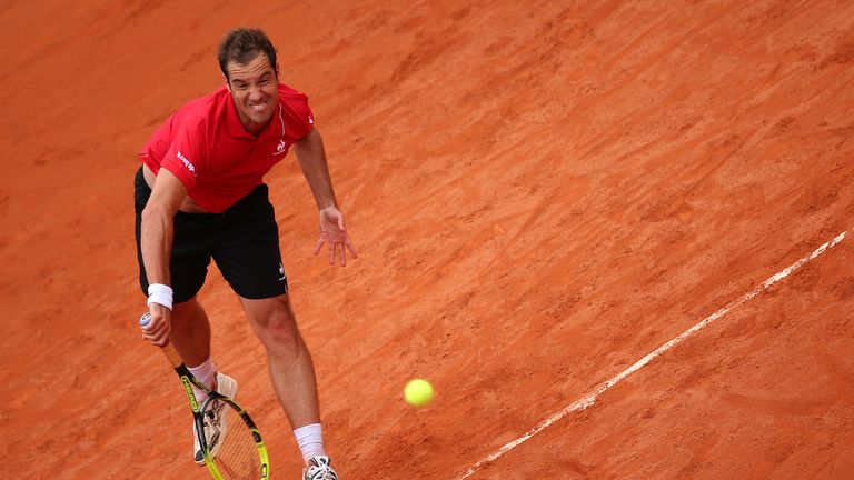 Richard Gasquet serves during his men's singles match against Bernard Tomic on day three of the French Open