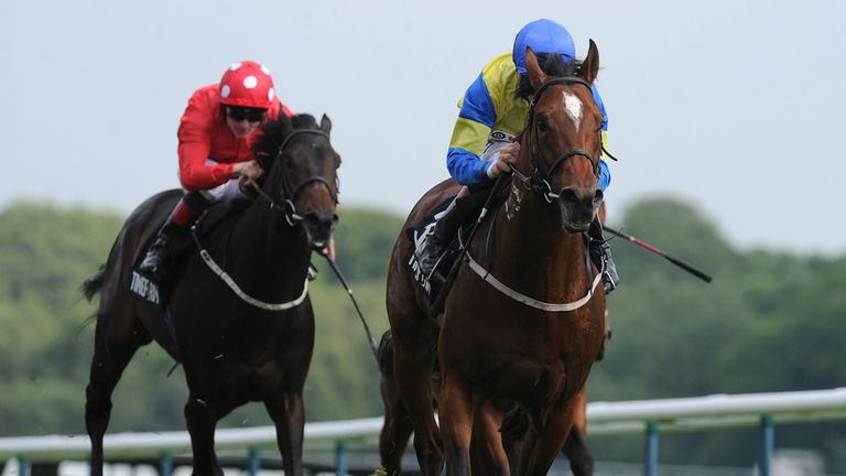 Aeolus ridden by Richard Hughes (right) wins the New Timeform Flags Sandy Lane Stakes 