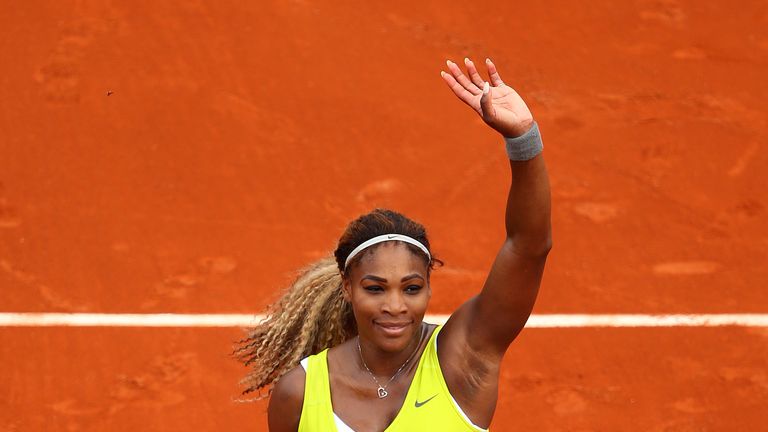 Defending champion Serena Williams celebrates victory over Alize Lim of France on day one of the French Open