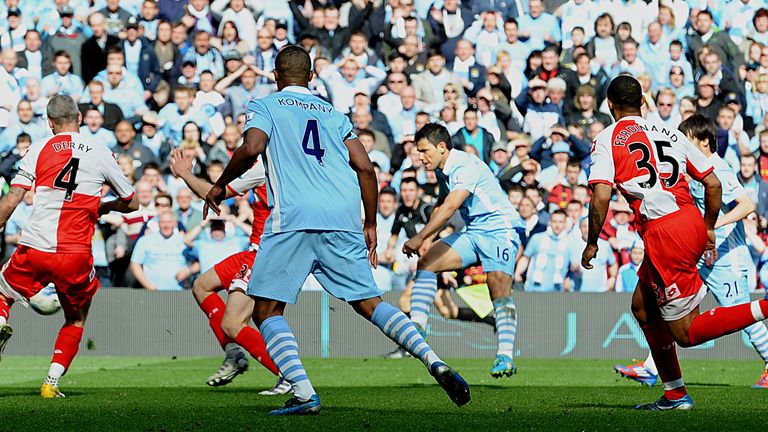 Manchester City's Argentinian striker Sergio Aguero (3rd R) scores their late winning goal during the English Premier League football match between Manches