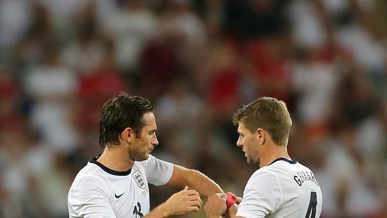 England's captain Steven Gerrard (right) hands the captain's armband over to team-mate Frank Lampard  