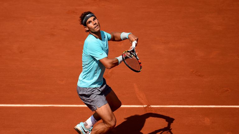 Reigning champ Rafael Nadal smashes the ball during his men's singles match against Leonardo Mayer. He is 6-2 7-5 ahead.