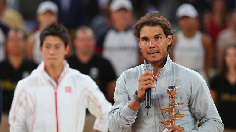 Rafael Nadal (right) speaks after beating Kei Nishikori (background, left) in the final of the Madrid Open. May 11 2014.