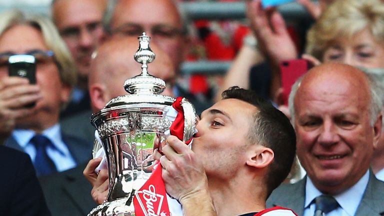Captain Thomas Vermaelen of Arsenal kisses the trophy in celebration after the FA Cup win over Hull City