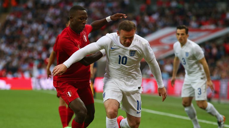 Watch your back: Wayne Rooney was marshalled by Luis Advincula