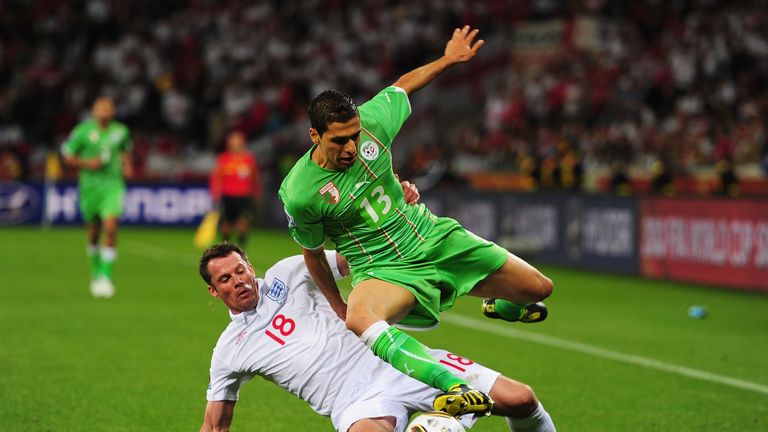 CAPE TOWN, SOUTH AFRICA - JUNE 18:  Jamie Carragher of England tackles Karim Matmour of Algeria during the 2010 FIFA World Cup South Africa Group C match b