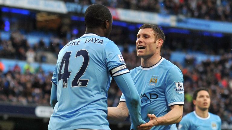 Manchester City's Yaya Toure and James Milner celebrate a goal against Fulham. Mar 22 2014.