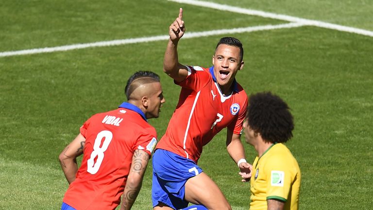 Chile forward Alexis Sanchez (C) celebrates after scoring a goal during the World Cup Round of 16 football match between Brazil and Chile in Belo Horizonte