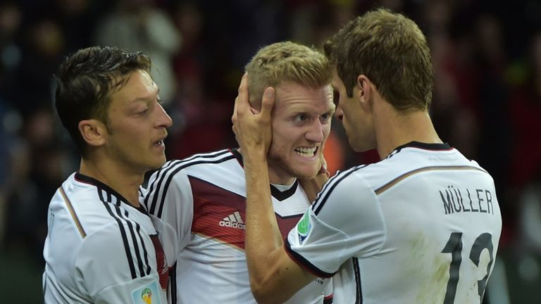 Germany's forward Andre Schuerrle celebrates (C) with his teammates Germany's forward Thomas Mueller (R) and Germany's midfielder Mesut Ozil