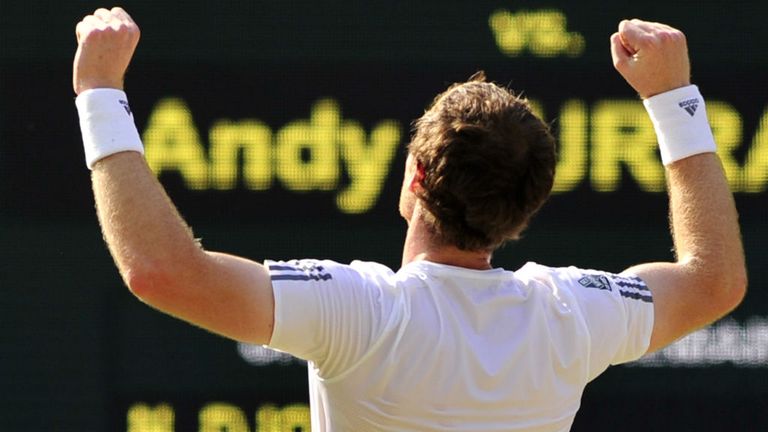 Britain's Andy Murray celebrates beating Serbia's Novak Djokovic during the men's singles final on day thirteen of the 2013 Wimbledon Championships