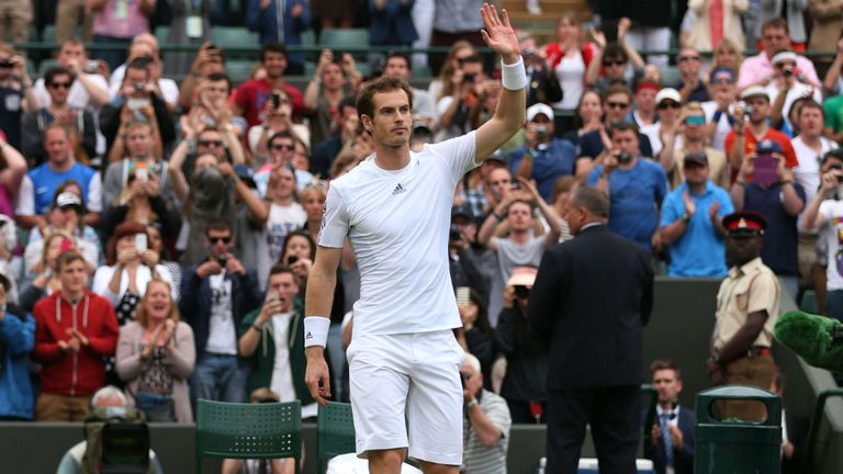 Andy Murray waves to the crowd as he celebrates match point during his second round match against Lu Yen-Hsun of Taipei at Wimbledon