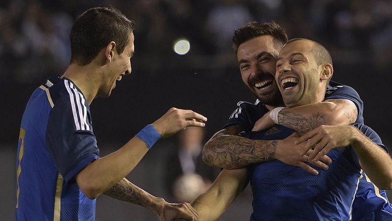 Argentina's midfielder Javier Mascherano (R) celebrates with teammates forward Ezequiel Lavezzi (C) and midfielder Angel Di Maria