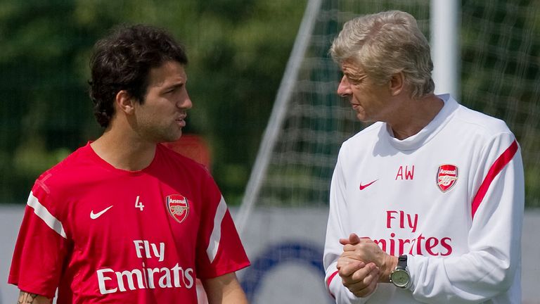 Arsenal's Cesc Fabregas (L) speaks to team manager manager Arsene Wenger during a training session at London Colney, north of London, in April 2011