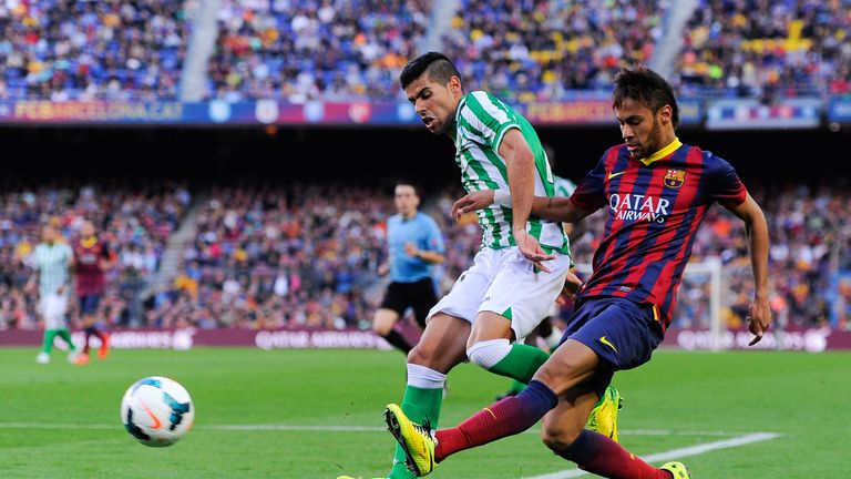 BARCELONA, SPAIN - APRIL 05: Neymar of FC Barcelona shoots towards goal under a challenge by 'Juanfran' Moreno of Real Betis Balompie during the La Liga ma