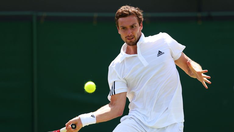 Ernests Gulbis plays a forehand during the 2013 Wimbledon tournament
