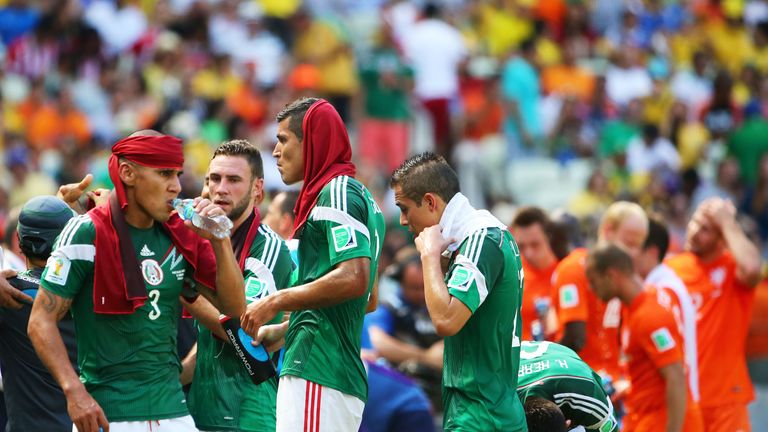 Carlos Salcido of Mexico takes on fluids during a cooling break in the 2014 FIFA World Cup Brazil Round of 16 match v the Netherlands