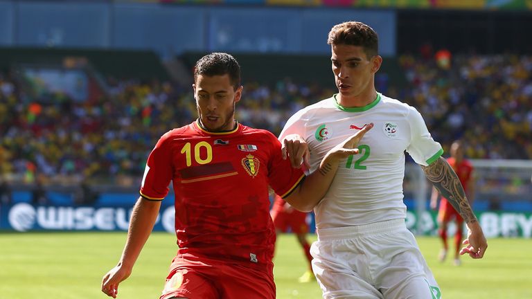 BELO HORIZONTE, BRAZIL - JUNE 17: Eden Hazard of Belgium holds off a challenge by Carl Medjani of Algeria during the 2014 FIFA World Cup Brazil Group H mat