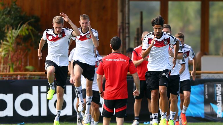 SANTO ANDRE, BRAZIL - JUNE 27: Matthias Ginter (L) and Sami Khedira of Germany jump during the German national team training at Campo Bahia 