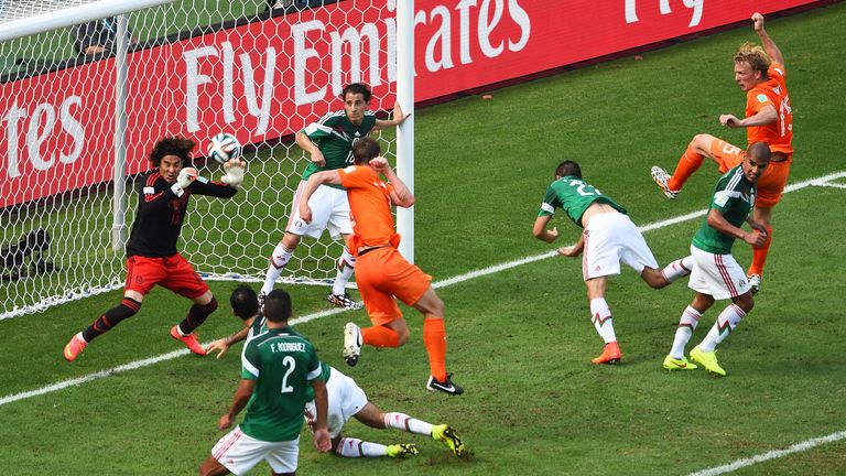 Mexico goalkeeper Guillermo Ochoa saves a shot by Stefan de Vrij of the Netherlands during the World Cup last-16 clash in Fortaleza
