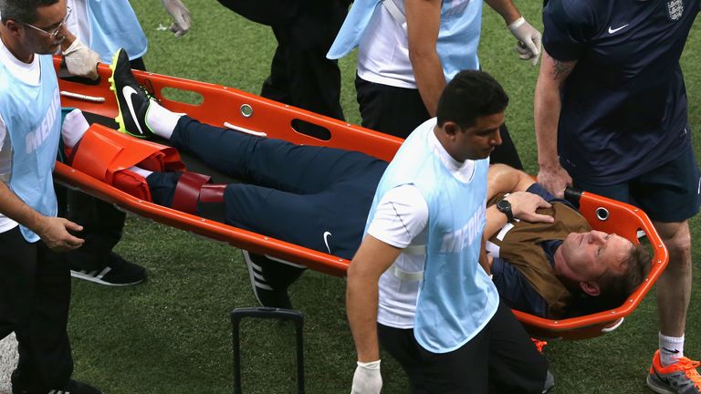 England trainer Gary Lewin is stretchered off the field after dislocating his ankle