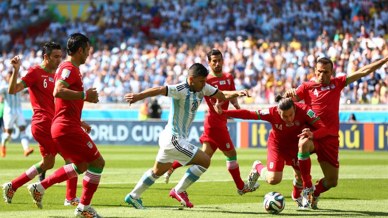 BELO HORIZONTE, BRAZIL - JUNE 21: Sergio Aguero of Argentina competes for the ball with Andranik Teymourian of Iran during the 2014 FIFA World Cup Brazil G