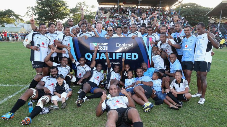 The Fiji team celebrate after qualifying for the 2015 Rugby Union World Cup