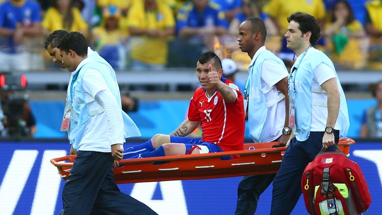  Gary Medel of Chile reacts while being stretchered off in extra time during the 2014 FIFA World Cup Brazil round of 16