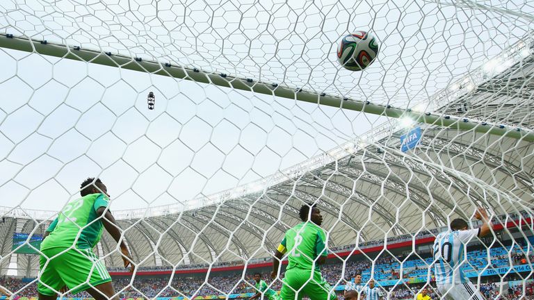PORTO ALEGRE, BRAZIL - JUNE 25: Lionel Messi of Argentina scores his team's first goal past Vincent Enyeama of Nigeria during the 2014 FIFA World Cup Brazi