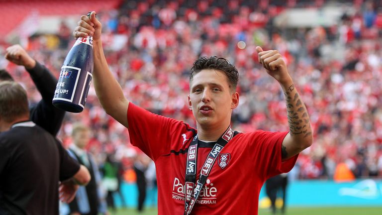Rotherham United's Tom Hitchcock celebrates promotion with the trophy after the game