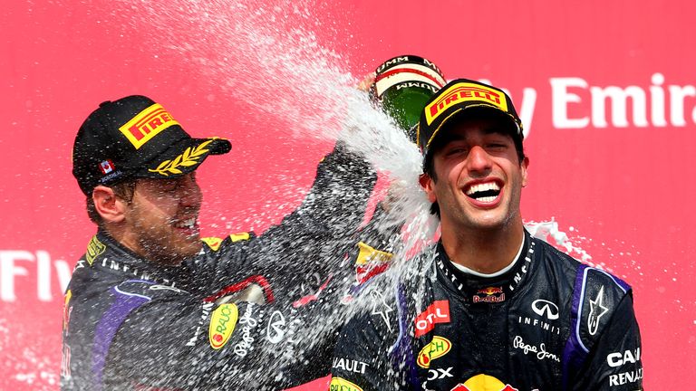 Racewinner Daniel Ricciardo is sprayed with champagne by team-mate Sebastian Vettel