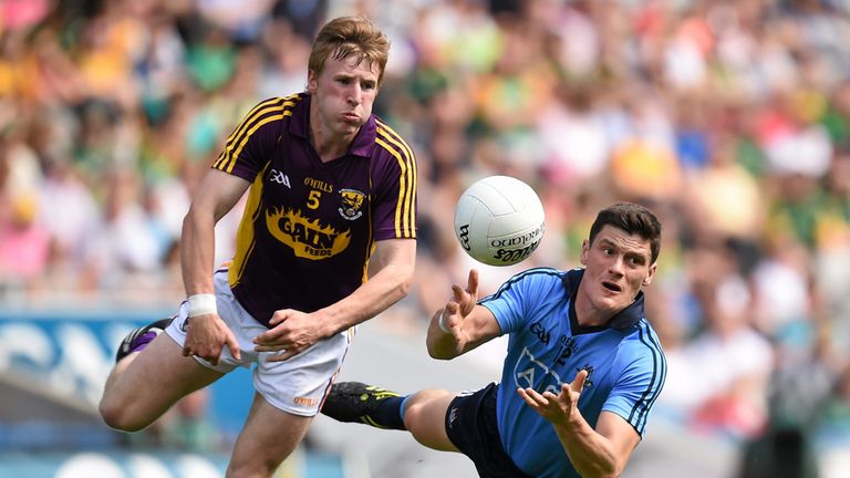 Diarmuid Connolly gets his pass away despite the efforts of Michael Furlong