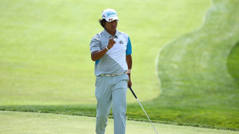 Hideki Matsuyama of Japan acknowledges the gallery after making his birdie putt on the 13th hole during the final round at Memorial