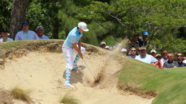 Rickie Fowler of the United States hits his second shot from a bunker on the ninth hole during the first round of the 114th US Open