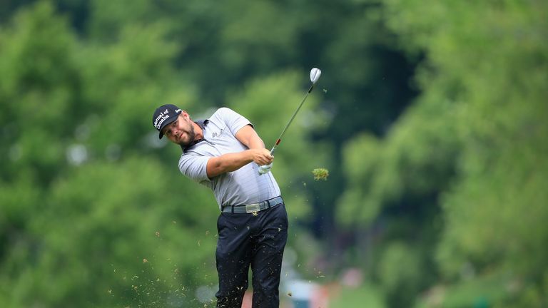 Ryan Moore of the United States watches his approach shot on the second hole during the third round of the Travelers Championship