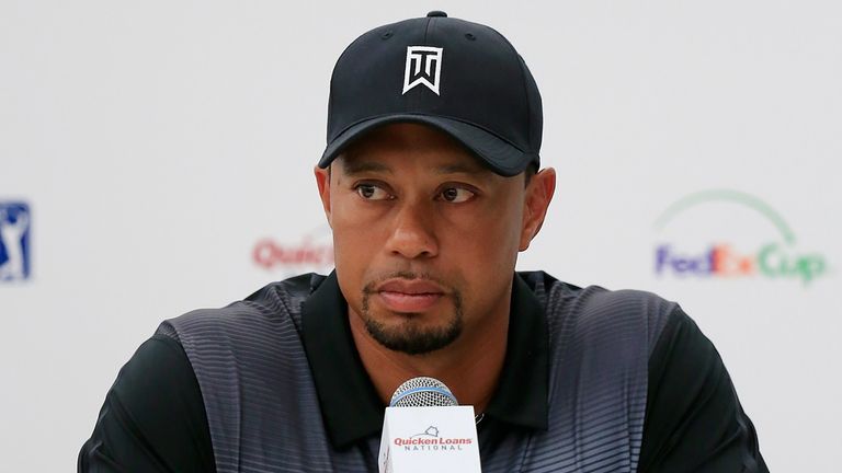 Tiger Woods talks with the media during a news conference at Congressional Country Club