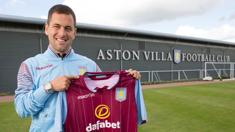 Joe Cole poses with an Aston Villa shirt after signing two-year deal
