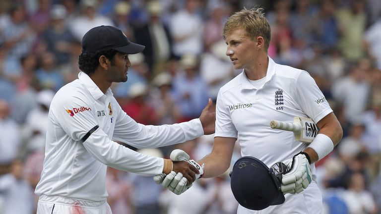 Dimuth Karunaratne shakes Joe Root's hand after the England batsman hit 200 not out on day two of first Test against Sri Lanka. June 13 2014.
