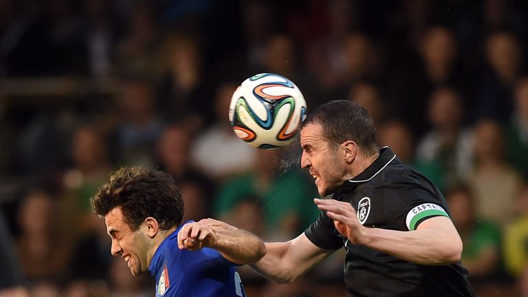 Giuseppe Rossi of Italy and John O'Shea of Ireland compete for the ball