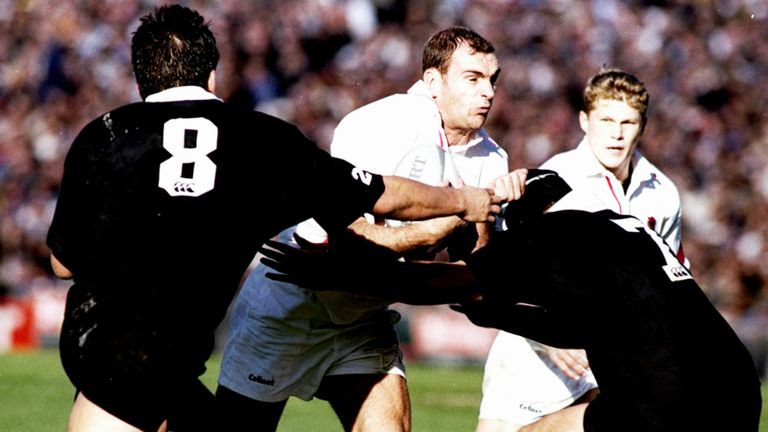 Jos Baxendell of England is tackled by Taine Randell and Josh Kronfeld during the second Test against New Zealand at Eden Park