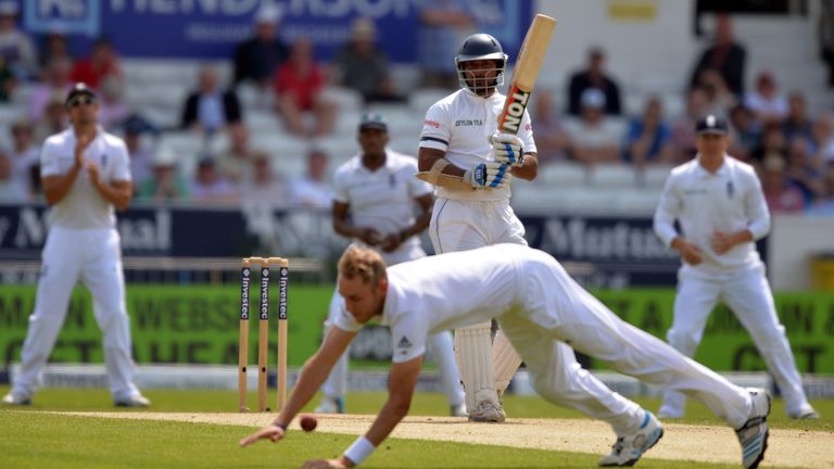 Sri Lamka's Kumar Sangakkara watches as England bowler Stuart Broad dives to stop the ball on the third day of the second test match