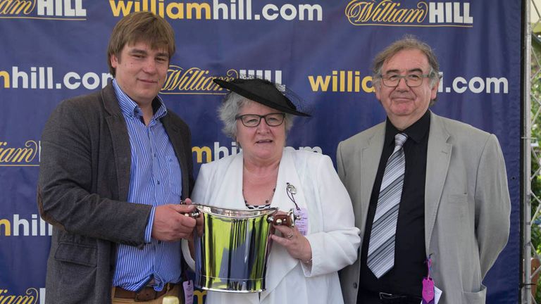 The winning trainer Dalgleish collects is prize