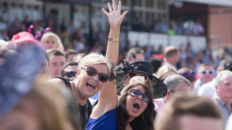 Racegoers cheer on the runners and riders during Stobo Castle Ladies Day at Musselburgh Racecourse