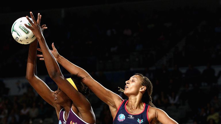 MELBOURNE, AUSTRALIA - APRIL 29:  Romelda Aiken of the Firebirds catches the ball infront of Geva Mentor of the Vixens during the round five ANZ Championsh